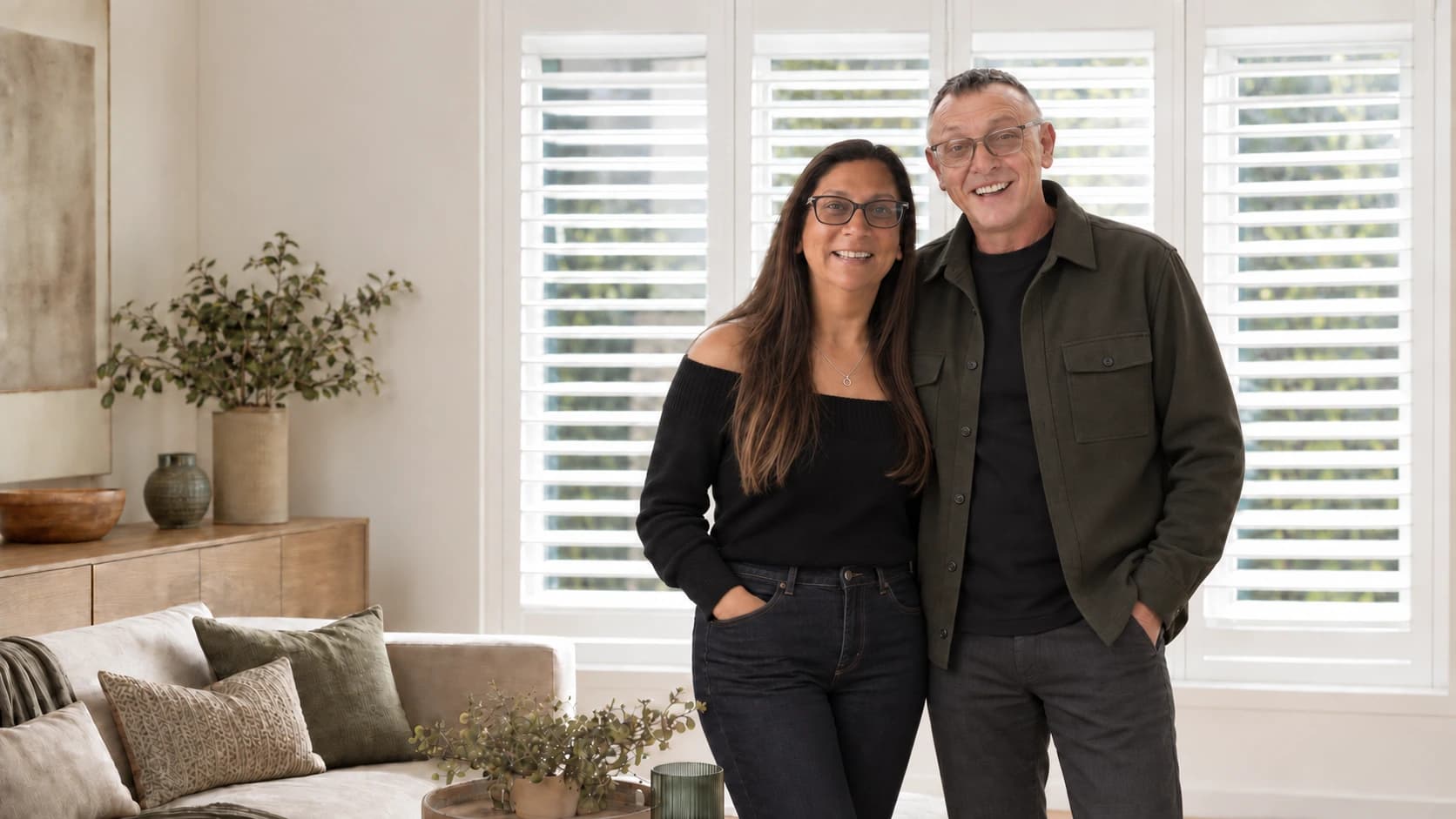 Kenny and Rama, co-founders of Shutters U Fit, in a room with plantation shutters